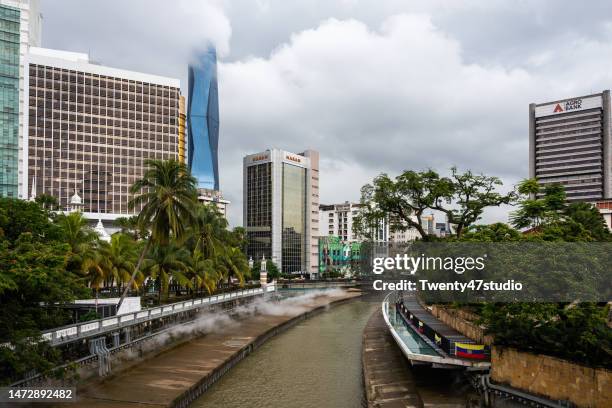 klang river among city skyline in rainy season in kuala lumpur - malaysia kuala lumpur merdeka square stock pictures, royalty-free photos & images