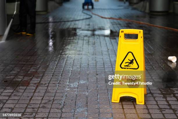 floor cleaning sign in the city - saftey sign stock pictures, royalty-free photos & images