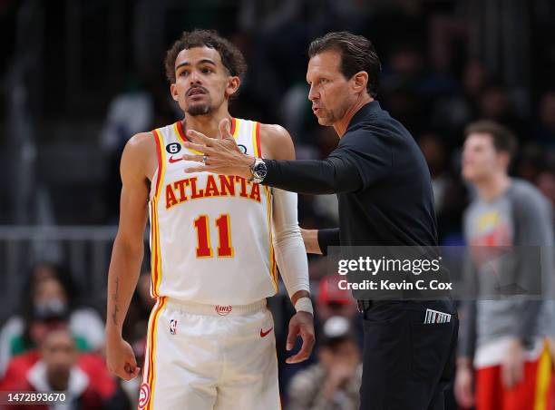 Head coach Quin Snyder of the Atlanta Hawks converses with Trae Young against the Boston Celtics during the third quarter at State Farm Arena on...