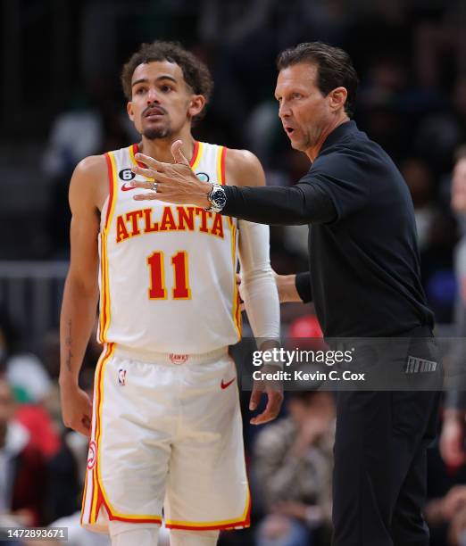 Head coach Quin Snyder of the Atlanta Hawks converses with Trae Young against the Boston Celtics during the third quarter at State Farm Arena on...