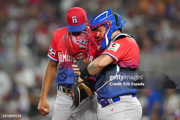 Sandy Alcantara of the Dominican Republic talks with catcher Gary Sanchez during the first inning against Venezuela at loanDepot park on March 11,...