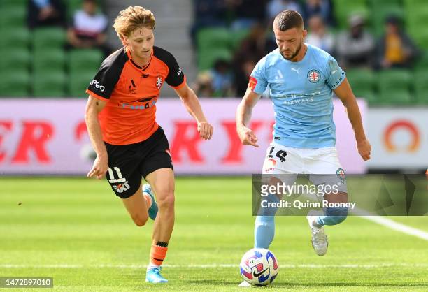 Valon Berisha of Melbourne City controls the ball infront of Jez Lofthouse of the Brisbane Roar during the round 20 A-League Men's match between...