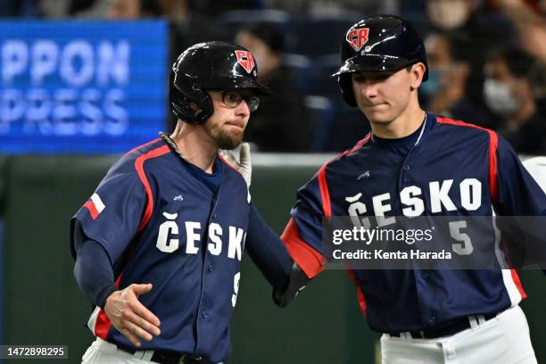 Eric Sogard of the Czech Republic celebrates with teammate William Escala after scoring a run by two-run double of Matej Mensik to make it 2-6 in the...