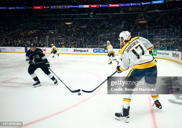 Mark Jankowski of the Nashville Predators skates the puck against Rasmus Kupari of the Los Angeles Kings in the second period at Crypto.com Arena on...