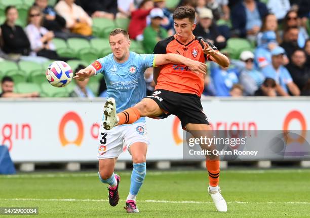 Scott Jamieson of Melbourne City and Rahmat Akbari of the Brisbane Roar compete for the ball during the round 20 A-League Men's match between...