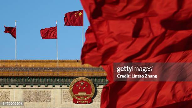 Chinese national flags flutter in front of the Great Hall of the People ahead of the fifth plenary session of the National People's Congress on March...