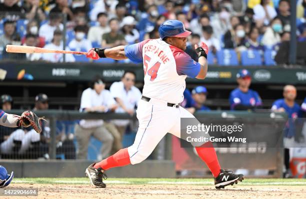 Alfredo Despaigne of Team Cuba hits a single at the bottom of the 5th inning during the World Baseball Classic Pool A game between Chinese Taipei and...