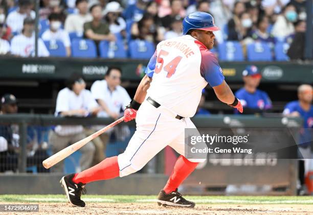 Alfredo Despaigne of Team Cuba hits a single at the bottom of the 5th inning during the World Baseball Classic Pool A game between Chinese Taipei and...