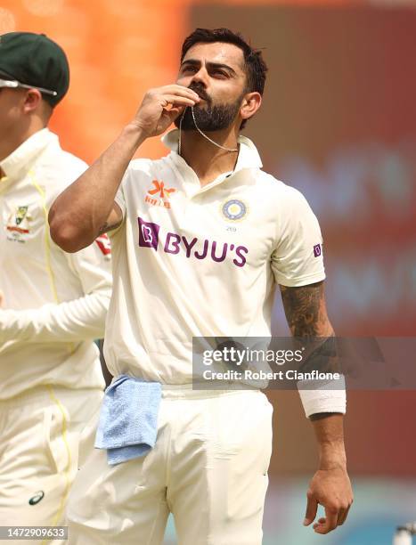 Virat Kohli of India celebrates after scoring his century during day four of the Fourth Test match in the series between India and Australia at...