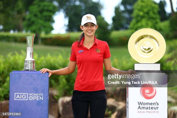 Eila Galitsky of Thailand poses with The AIG Women's Open trophy and The Women's Amateur Asia-Pacific Championship trophy during Day Four of The...