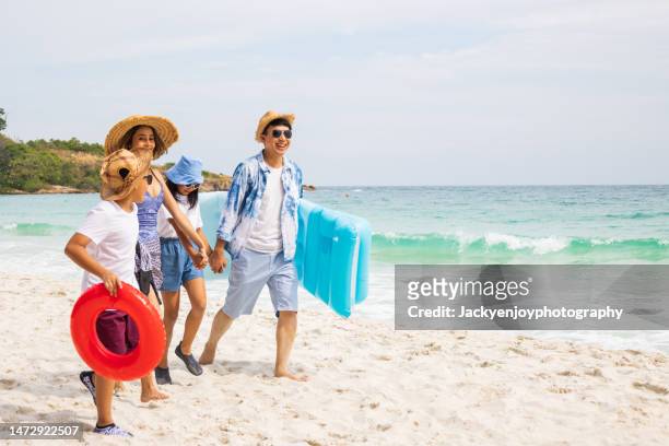 parents with children enjoying vacation on beach - ankle deep in water stock pictures, royalty-free photos & images