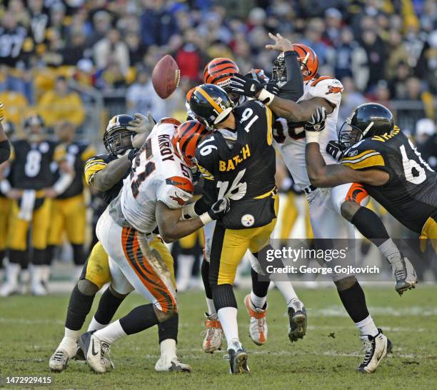 Linebackers Kevin Hardy#51 and Brian Simmons of the Cincinnati Bengals hit quarterback Charlie Batch of the Pittsburgh Steelers causing a fumble as...