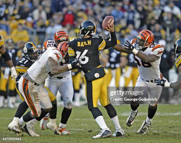 Linebacker Kevin Hardy of the Cincinnati Bengals pulls on the jersey of quarterback Charlie Batch of the Pittsburgh Steelers as defensive lineman...