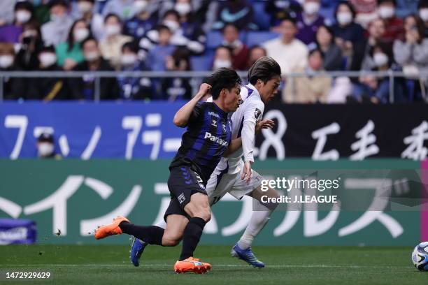 Tsukasa MORISHIMA of Sanfrecce Hiroshima and Riku HANDA of Gamba Osaka tussle during the J.LEAGUE Meiji Yasuda J1 4th Sec. Match between Gamba Osaka...