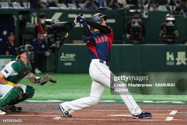 Shohei Ohtani of Japan hits a three run home run to make it 3-0 in the first inning during the World Baseball Classic Pool B game between Japan and...