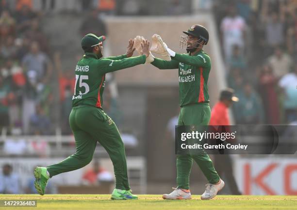 Liton Das and Shakib Al Hasan of Bangladesh celebrates the wicket of Chris Woakes of England during the 2nd T20 International between Bangladesh and...