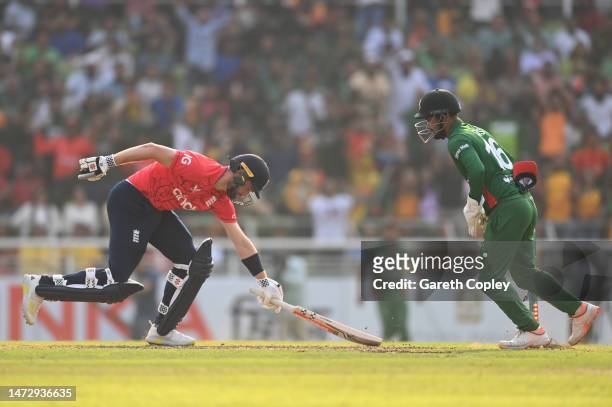 Chris Woakes of England is stumped by Liton Das of Bangladesh during the 2nd T20 International between Bangladesh and England at Sher-e-Bangla...