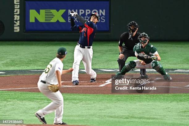 Shohei Ohtani of Japan hits a three run home run to make it 3-0 in the first inning during the World Baseball Classic Pool B game between Japan and...