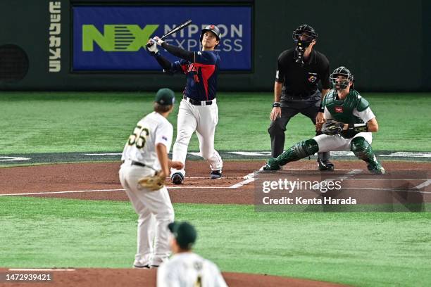 Shohei Ohtani of Japan hits a three run home run to make it 3-0 in the first inning during the World Baseball Classic Pool B game between Japan and...