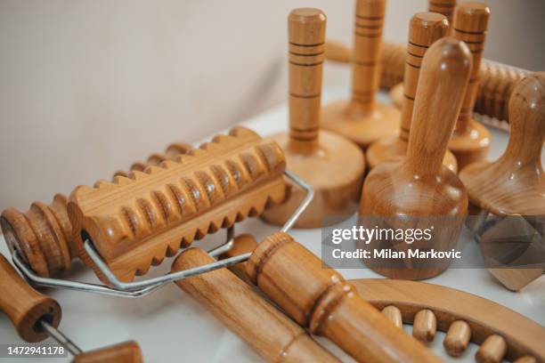 wooden rolling pin or battledore tools for anti-cellulite treatment to stimulate the lymphatic system and improve the concept of circulation - massagebal stockfoto's en -beelden