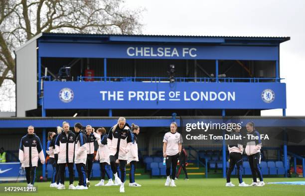 Players of Manchester United inspect the pitch prior to the FA Women's Super League match between Chelsea and Manchester United at Kingsmeadow on...