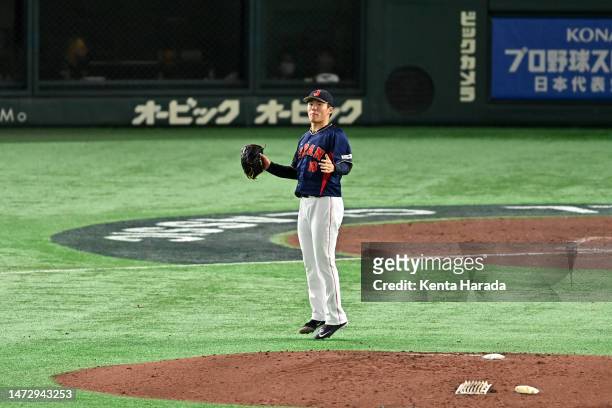 Yoshinobu Yamamoto of Japan reacts after the fourth inning during the World Baseball Classic Pool B game between Japan and Australia at Tokyo Dome on...