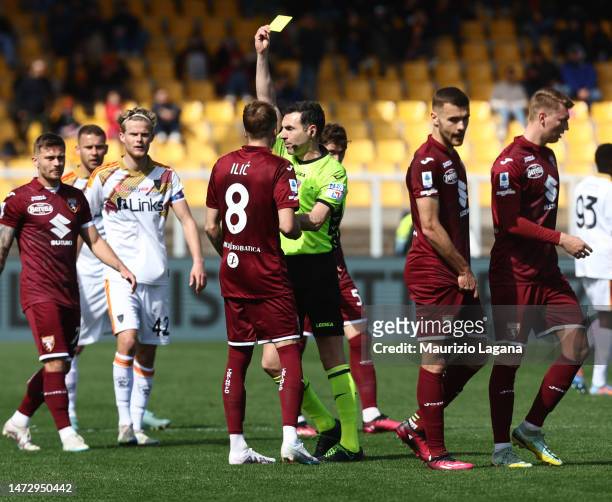 The referee Juan Luca Sacchi shows the yellow card to Ivan Ilic of Torino during the Serie A match between US Lecce and Torino FC at Stadio Via del...