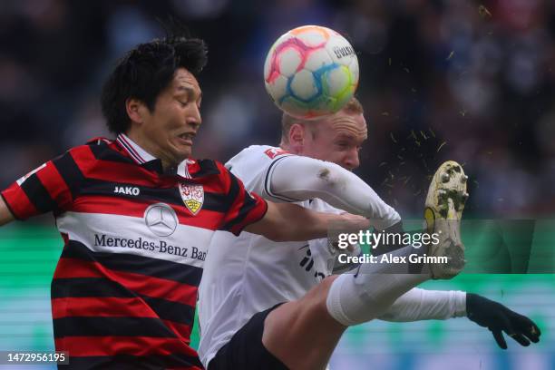 Genki Haraguchi of VfB Stuttgart is challenged by Sebastian Rode of Eintracht Frankfurt during the Bundesliga match between Eintracht Frankfurt and...