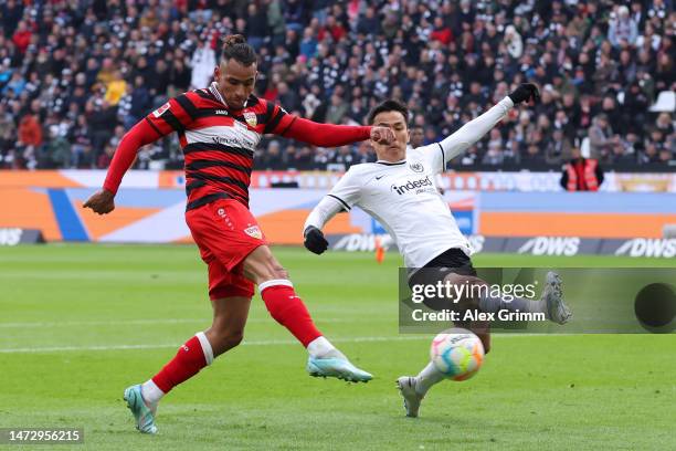 Juan Jose Perea of Stuttgart is challenged by Makoto Hasebe of Eintracht Frankfurt during the Bundesliga match between Eintracht Frankfurt and VfB...