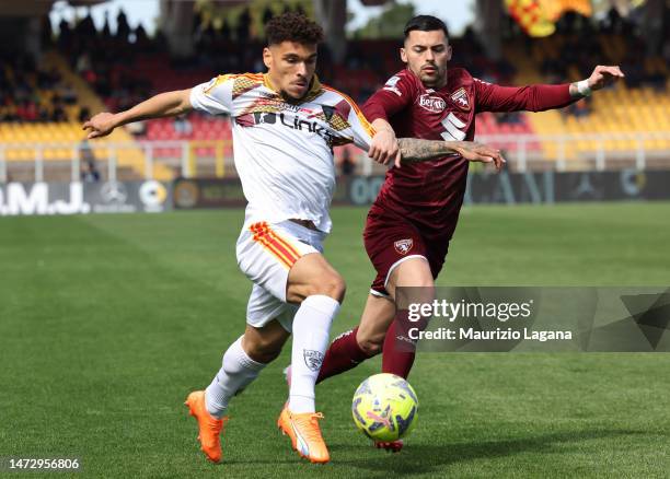 Valentin Gendrey of Lecce competes for the ball with Nemanja Radonjic of Torino during the Serie A match between US Lecce and Torino FC at Stadio Via...