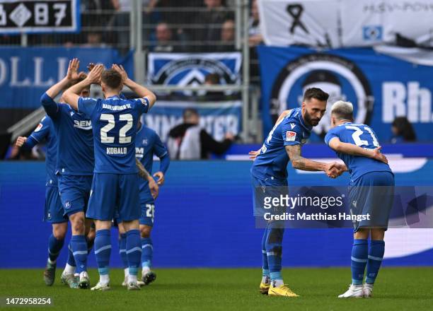 Fabian Schleusener of Karlsruher SC celebrates with teammate Marco Thiede after scoring the team's third goal during the Second Bundesliga match...