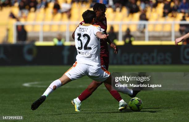 Youssef Maleh of Lecce competes for the ball with Wilfried Singo of Torino during the Serie A match between US Lecce and Torino FC at Stadio Via del...