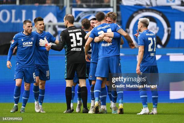 Fabian Schleusener of Karlsruher SC celebrates with teammates after scoring the team's third goal during the Second Bundesliga match between...