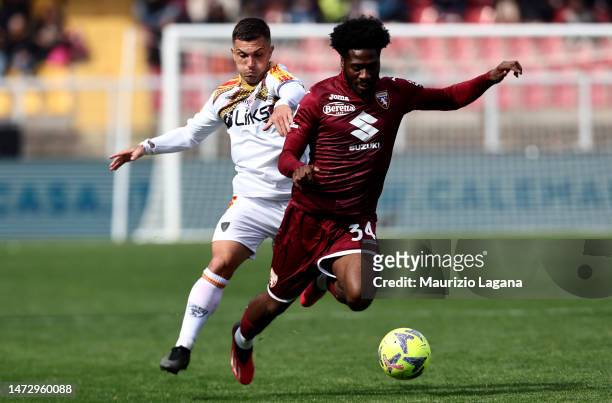 Gabriel Strefezza of Lecce competes for the ball with Ola Aina of Torino during the Serie A match between US Lecce and Torino FC at Stadio Via del...