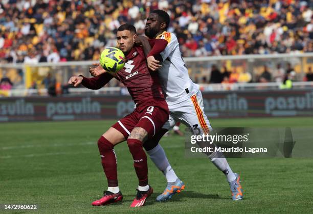 Samuel Umtiti of Lecce competes for the ball with Antonio Sanabria of Torino during the Serie A match between US Lecce and Torino FC at Stadio Via...