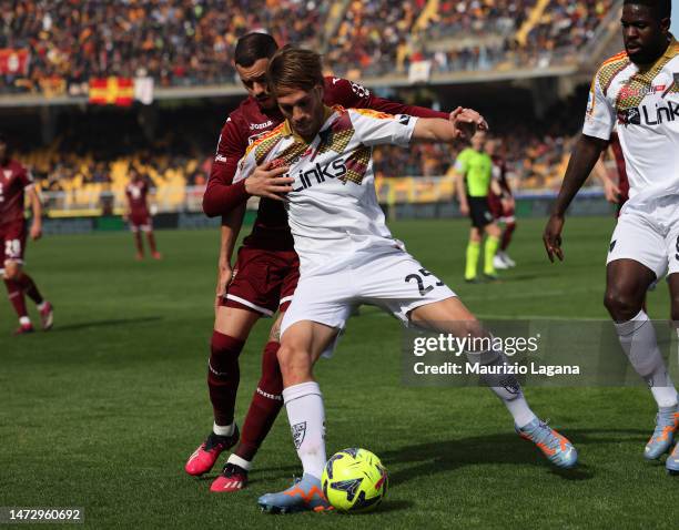 Antonino Gallo of Lecce competes for the ball with Antonio Sanabria of Torino during the Serie A match between US Lecce and Torino FC at Stadio Via...