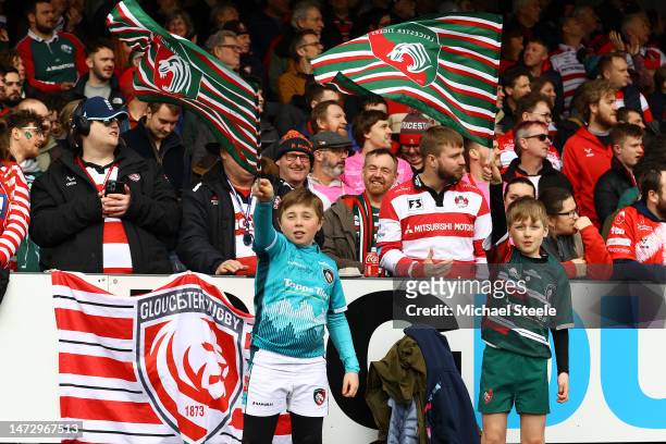 Young Leicester Tigers supporters wave their flags during the Gallagher Premiership Rugby match between Gloucester Rugby and Leicester Tigers at...