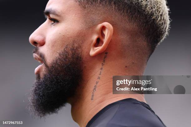 Detailed view of the tattoo on the neck of Douglas Luiz of Aston Villa, which reads #FavelaVenceu, prior to the Premier League match between West Ham...