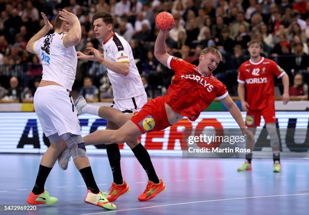 Tim Zechel and Lukas Stutzke of Germany challenge Emil Bergholt of Denmark during the EHF Euro Cup match between Germany and Denmark at Barclay Arena...