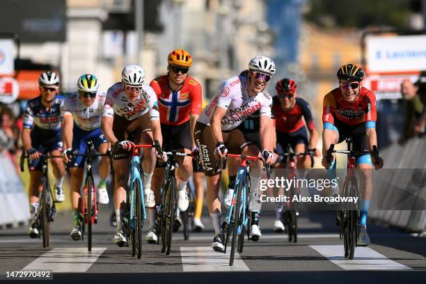 Stan Dewulf of Belgium and Ag2R Citroen Team and Fred Wright of The United Kingdom and Team Bahrain Victorious cross the finish line during the 81st...