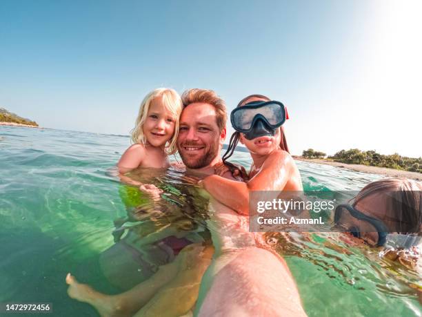 family day swimming at the beach - dykmask bildbanksfoton och bilder