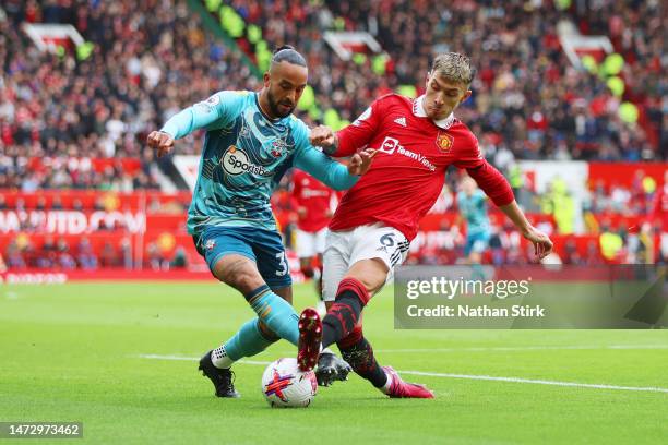 Theo Walcott of Southampton is challenged by Lisandro Martinez of Manchester United during the Premier League match between Manchester United and...