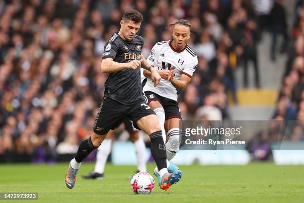 Granit Xhaka of Arsenal passes the ball whilst under pressure from Bobby Reid of Fulham during the Premier League match between Fulham FC and Arsenal...
