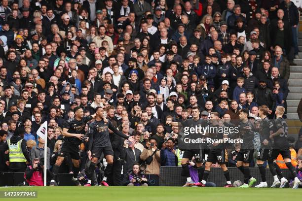 Gabriel of Arsenal celebrates after scoring the team's first goal with teammate William Saliba during the Premier League match between Fulham FC and...