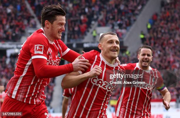 Maximilian Eggestein of Sport-Club Freiburg celebrates with teammate Michael Gregoritsch after scoring the side's first goal during the Bundesliga...