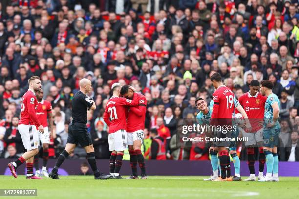 Casemiro of Manchester United is consoled by teammate Antony as he looks dejected after being shown a red card by match referee Anthony Taylor during...