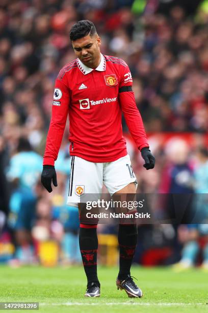 Casemiro of Manchester United looks dejected as he leaves the pitch after being shown a red card during the Premier League match between Manchester...