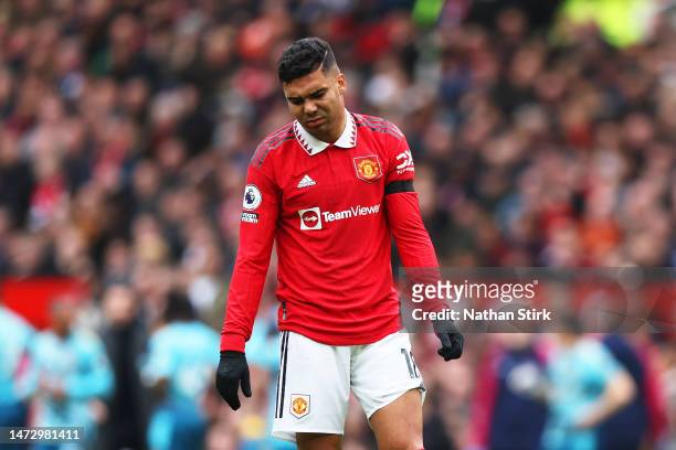 Casemiro of Manchester United looks dejected as he leaves the pitch after being shown a red card during the Premier League match between Manchester...