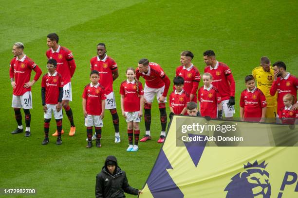 The two teams shake hands ahead of the Premier League match between Manchester United and Southampton FC at Old Trafford on March 12, 2023 in...