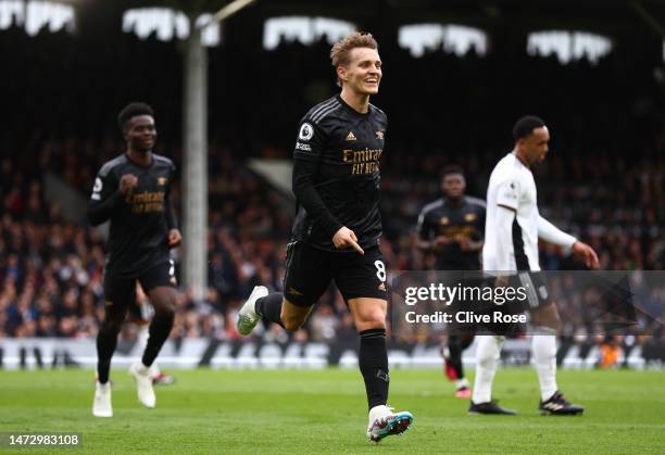 Martin Odegaard of Arsenal celebrates after scoring the team's third goal during the Premier League match between Fulham FC and Arsenal FC at Craven...